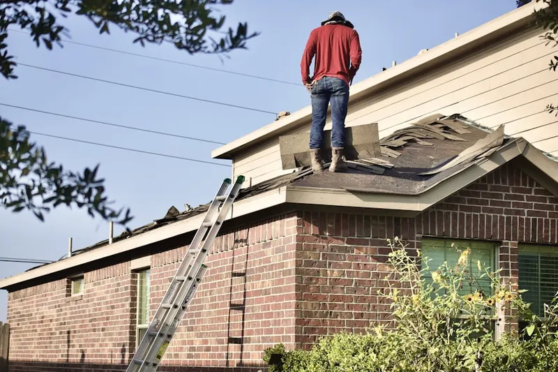 Professional roofer working on a residential roof in Berkeley Village